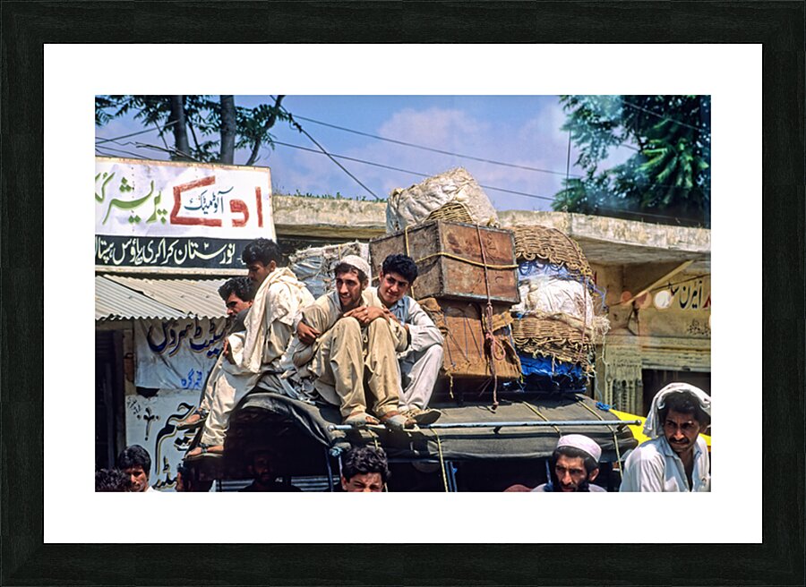 Men travel on top of a vehicle in Peshawar Pakistan Picture Frame print