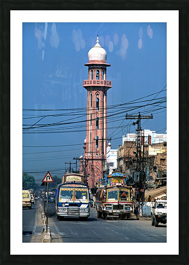 Busy street scene with tall tower in Peshawar Pakistan Picture Frame print