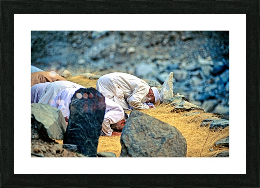 Muslim men pray towards Mecca in Pakistan during prayer time Picture Frame print