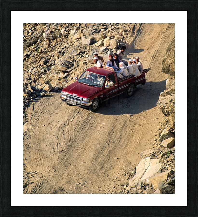 Travelers on gravel road near Shandur Pass in Pakistan Picture Frame print