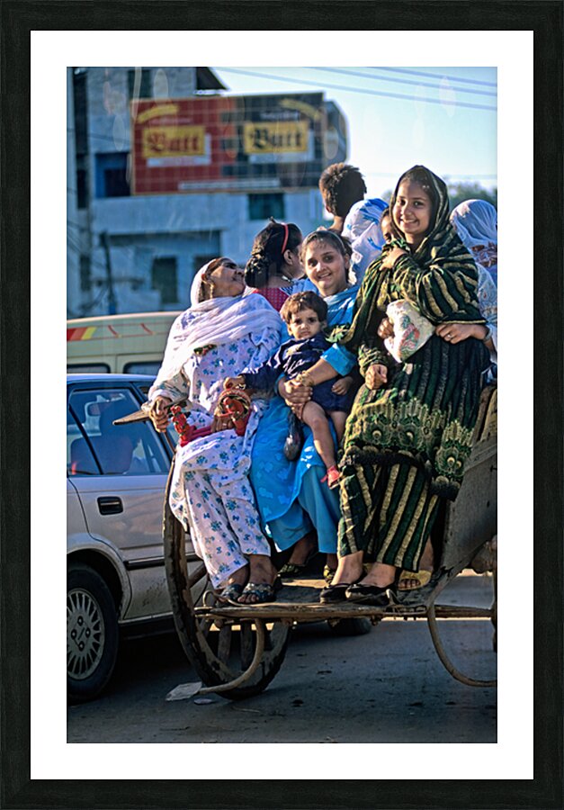 Family travels on rickshaw in busy Lahore streets Picture Frame print