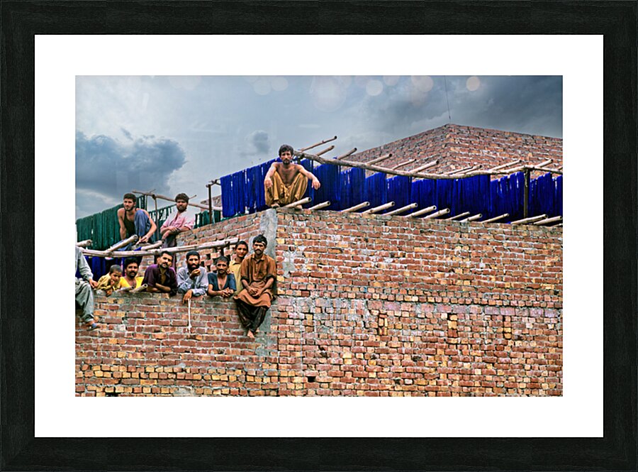 Workers rest during break time at a construction site in Lahore Picture Frame print