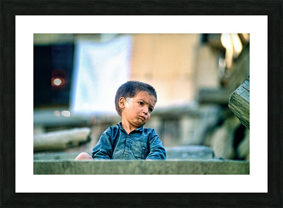Sad boy sitting on stairs in Lahore Pakistan during the day Picture Frame print