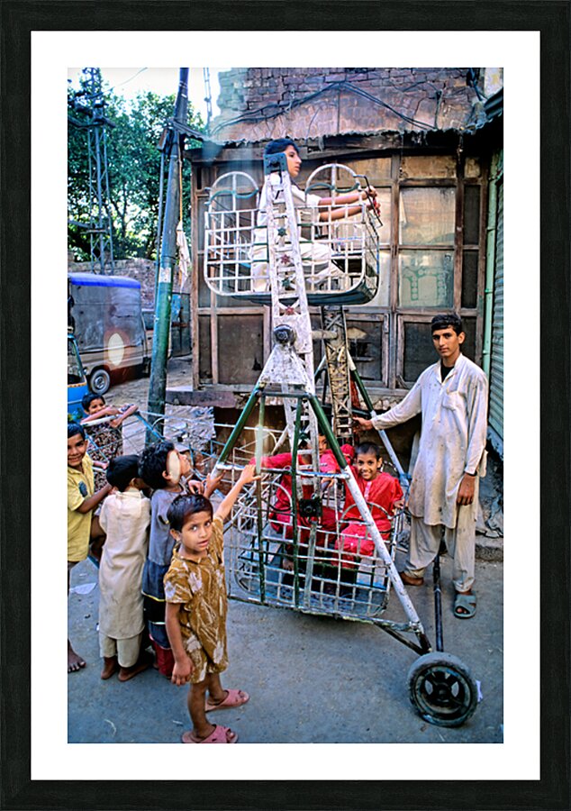 Children enjoy playtime on a swing in Lahore Picture Frame print