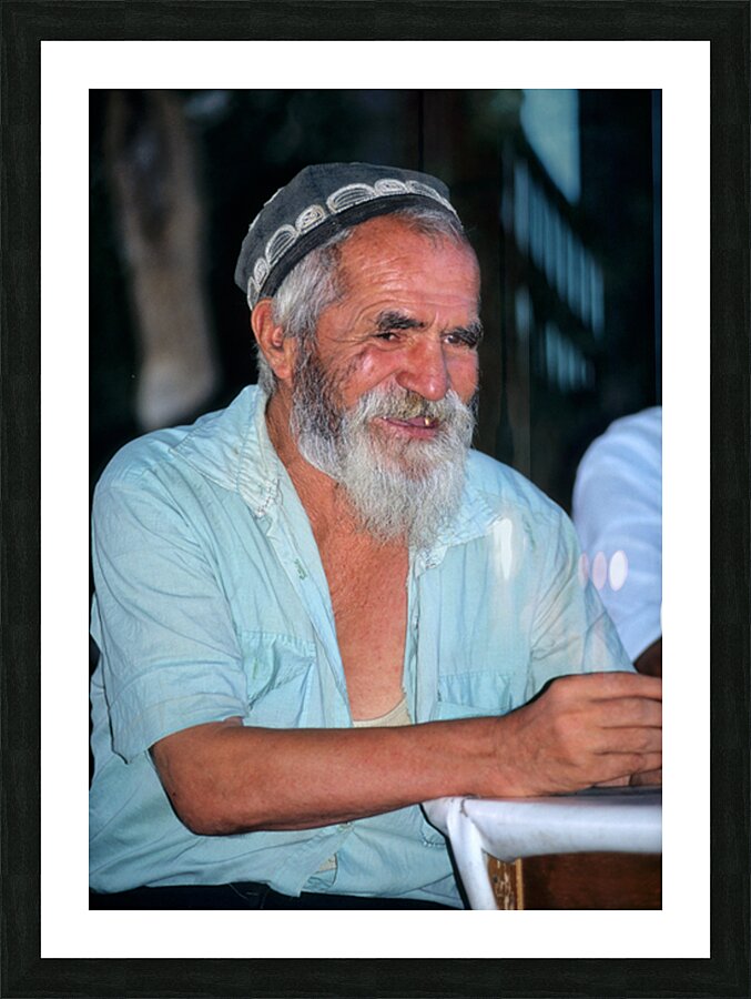 Elderly man smiles while sitting outdoors in Bukhara Uzbekistan Picture Frame print