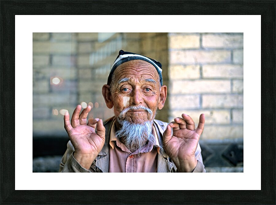 Elderly man showing hand gestures in Khiva Uzbekistan Picture Frame print