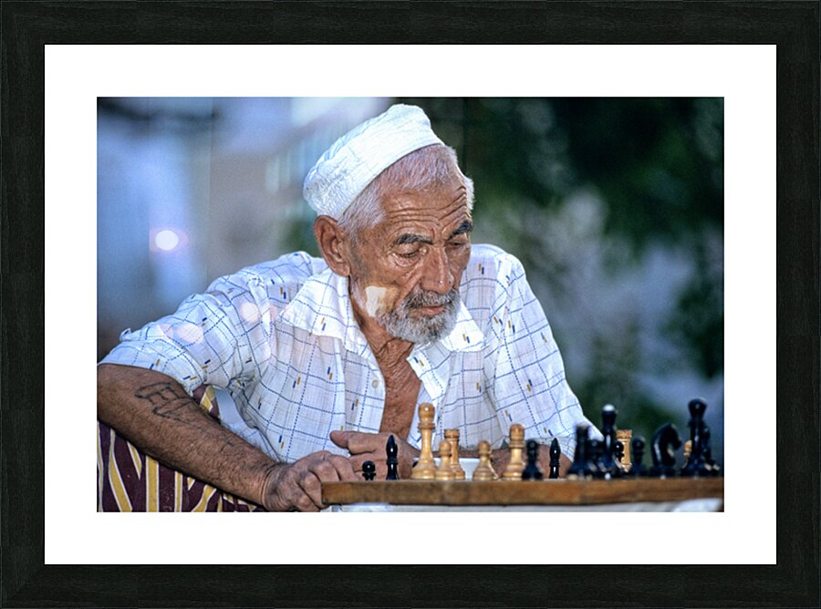 Elderly man plays chess in Bukhara Uzbekistan Picture Frame print