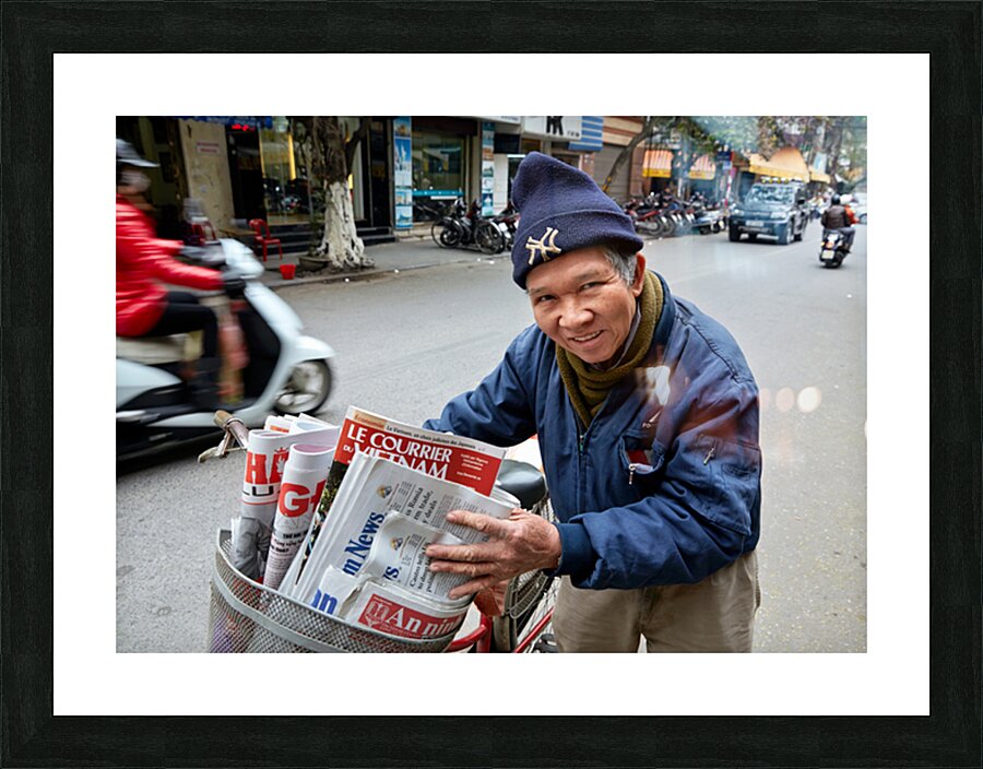 Man selling newspapers in Ho Chi Minh City Picture Frame print