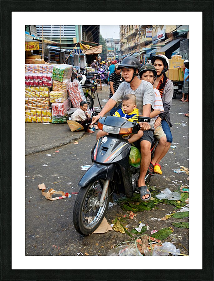 Motorbike family ride through busy Ho Chi Minh street in Vietnam Picture Frame print