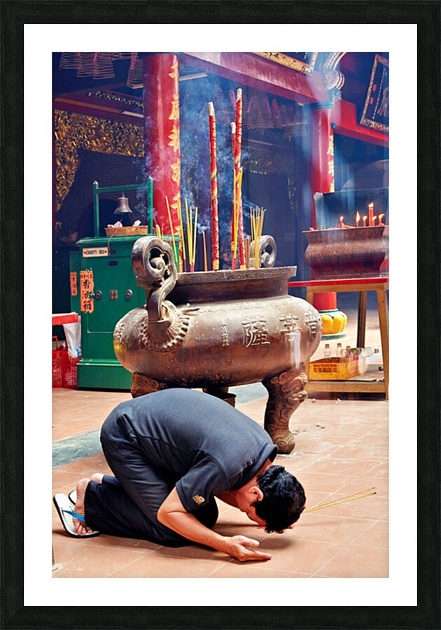 Man praying at a shrine in Ho Chi Minh City Vietnam Picture Frame print