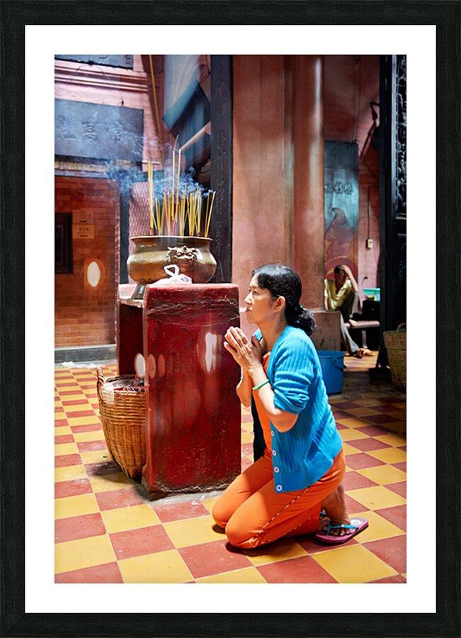Woman prays at a temple in Ho Chi Minh City Vietnam Picture Frame print