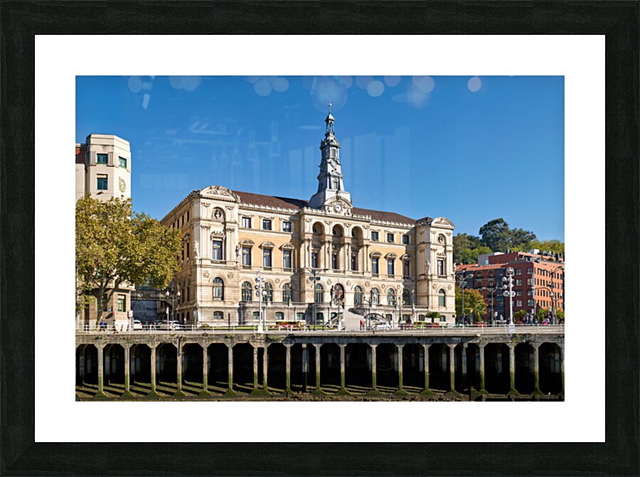 Building stands in Bilbao Spain next to water and trees Picture Frame print