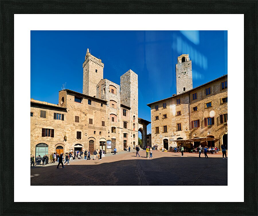 Visitors explore Piazza della Cisterna in San Gimignano Picture Frame print