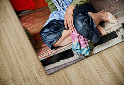 Elderly person sitting on floor in rustic dwelling. Marco Brivio puzzle