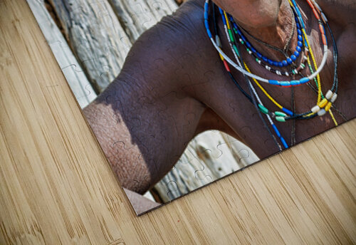 Old woman of Zemba Bantu ethnic group sits near wooden wall in N Marco Brivio puzzle