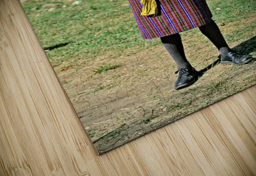Bhutanese archer in traditional Gho aiming a compound bow. Marco Brivio puzzle