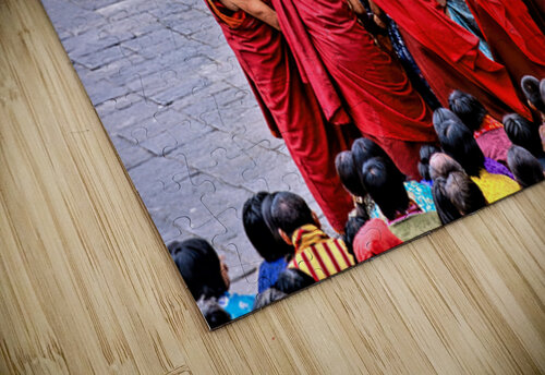 Monks in red robes gathered around a golden statue. Marco Brivio puzzle