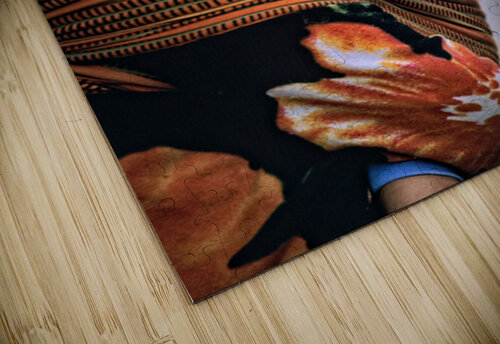 Curious child carried in a patterned fabric sling. Marco Brivio puzzle