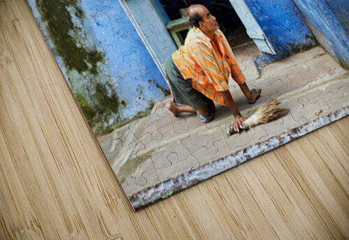Man sweeps in front of home in Bundi Rajasthan during the day Marco Brivio puzzle