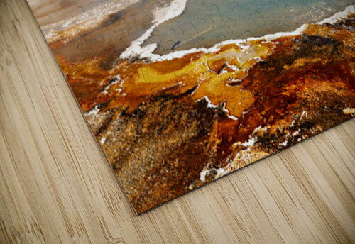 Steam rises from Abyss Pool as blue water reflects the surrounding landscape at Yellowstone National Park. Visitors explore the area nearby. Marco Brivio puzzle