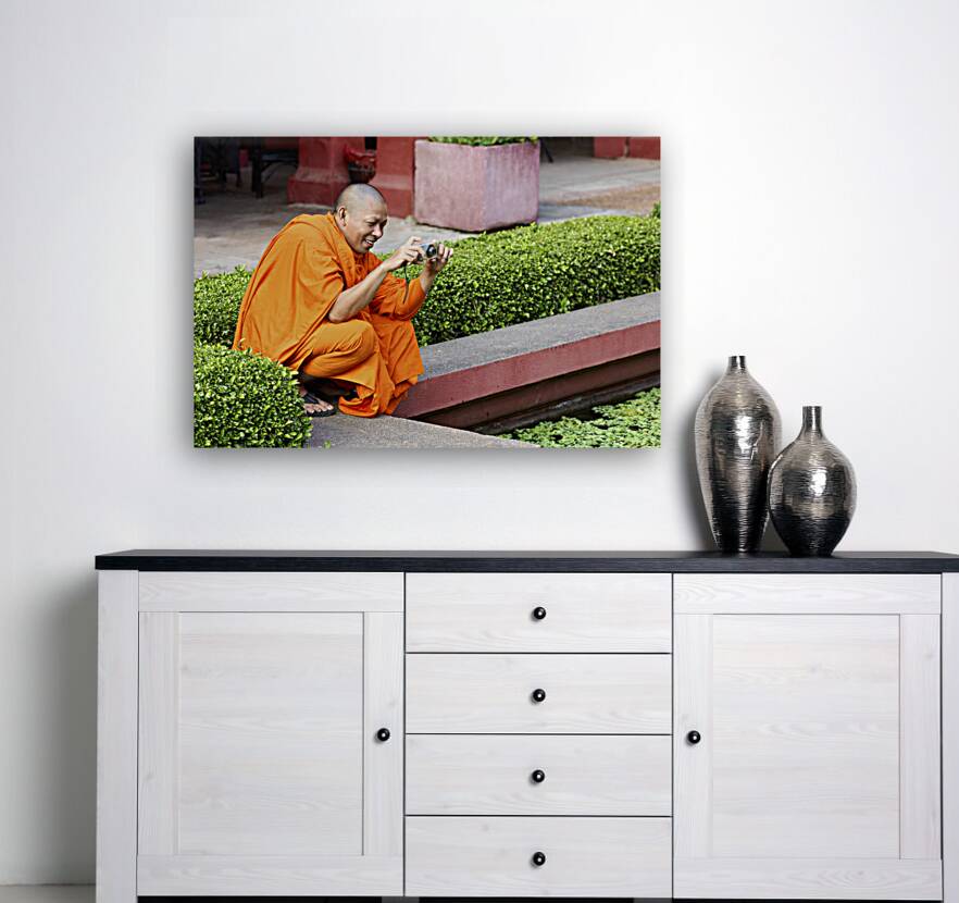 A buddhist monk taking a picture at the National Museum of Cambodia in Phnom Penh Reproduction