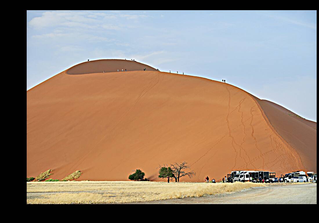 Namibia. Climbing the sand dunes at Sossusvlei. Namib Naukluft National Park Reproduction