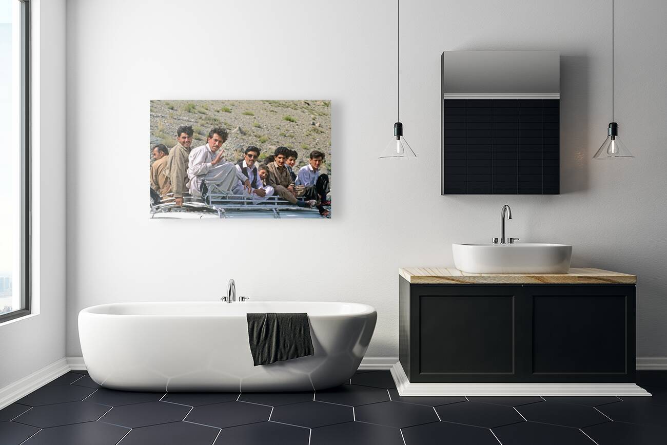 Pakistan. People travelling on the roof of a van Reproduction