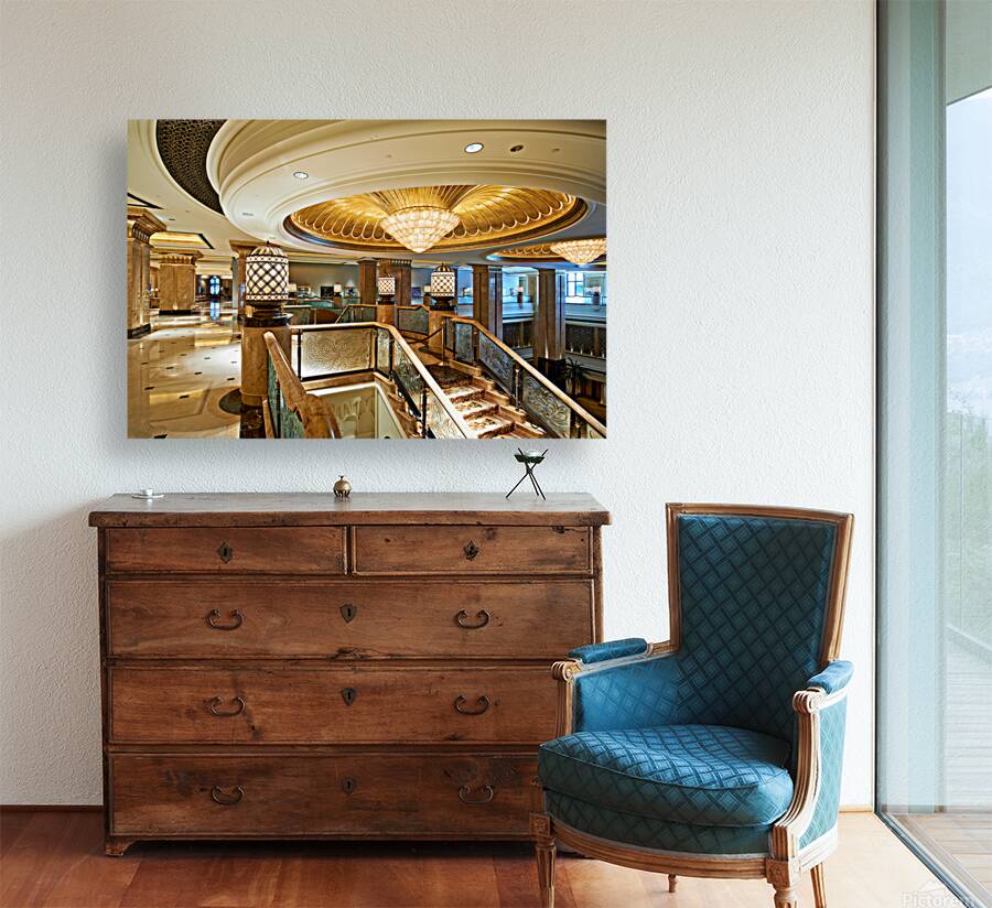 Opulent hotel lobby with grand staircase and golden chandeliers. Reproduction