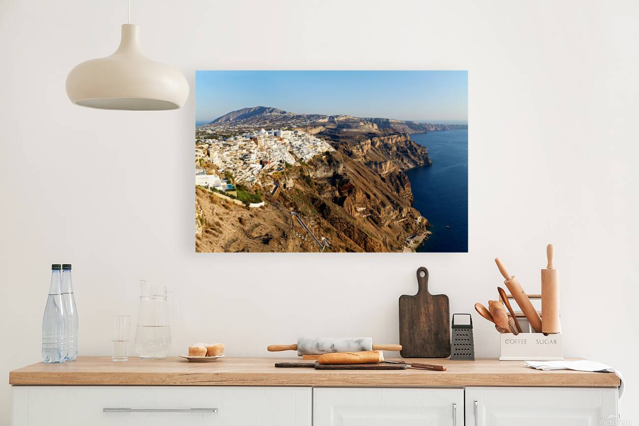 Santorinis white buildings on caldera cliffs above the sea. Reproduction
