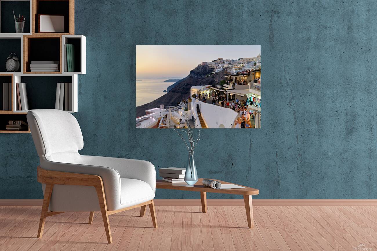 Santorini cliffside town with restaurants and people enjoying th Reproduction