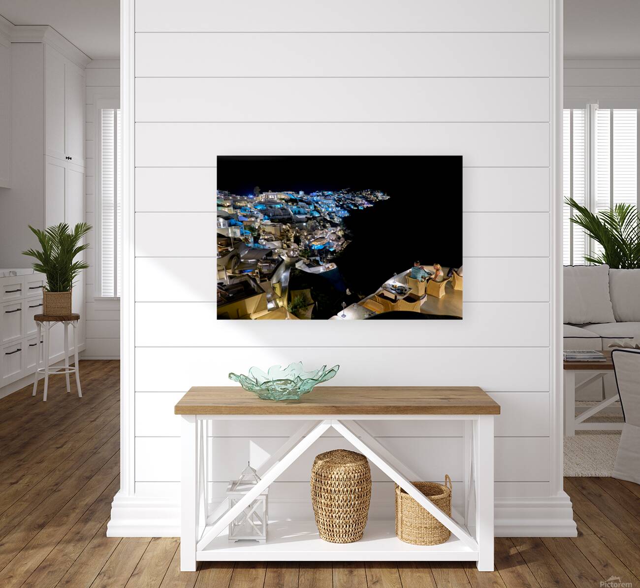 Illuminated cliffside town at night couple enjoying dinner. Reproduction