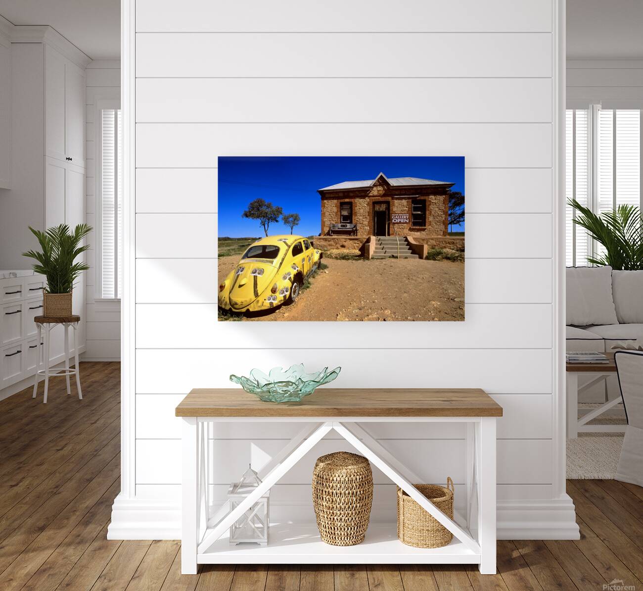 A painted yellow Beetle outside a rural stone gallery. Reproduction