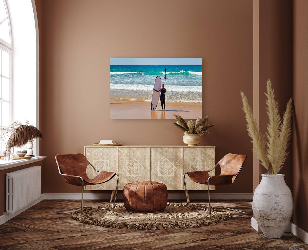 Surfer girl with surfboard on beach watching waves Reproduction