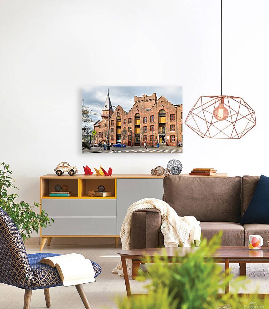 Historic brick building with a tower and people walking. Reproduction