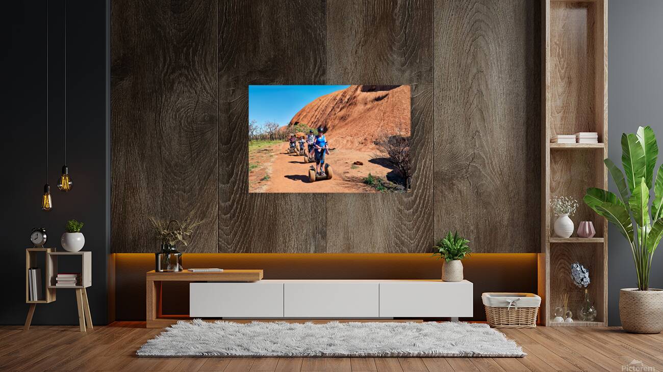Tourists ride Segways near Uluru in Australia. Reproduction