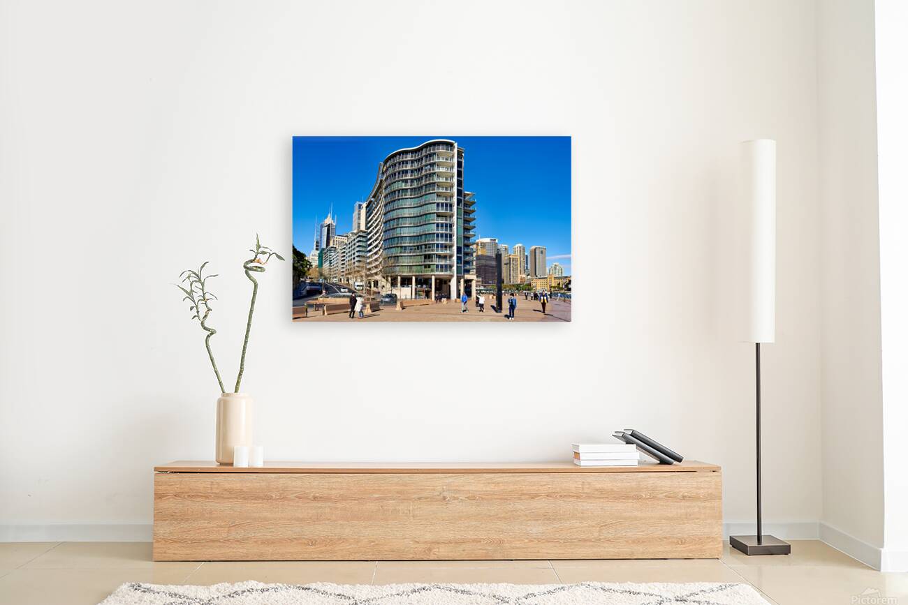 Modern curved building with balconies and city skyline. Reproduction