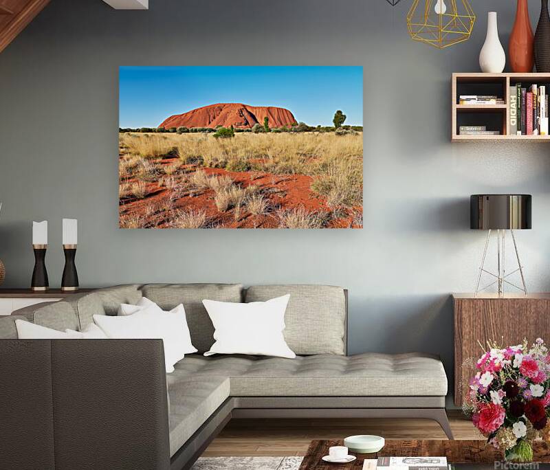 Uluru Australias iconic sandstone monolith under a clear blue Reproduction