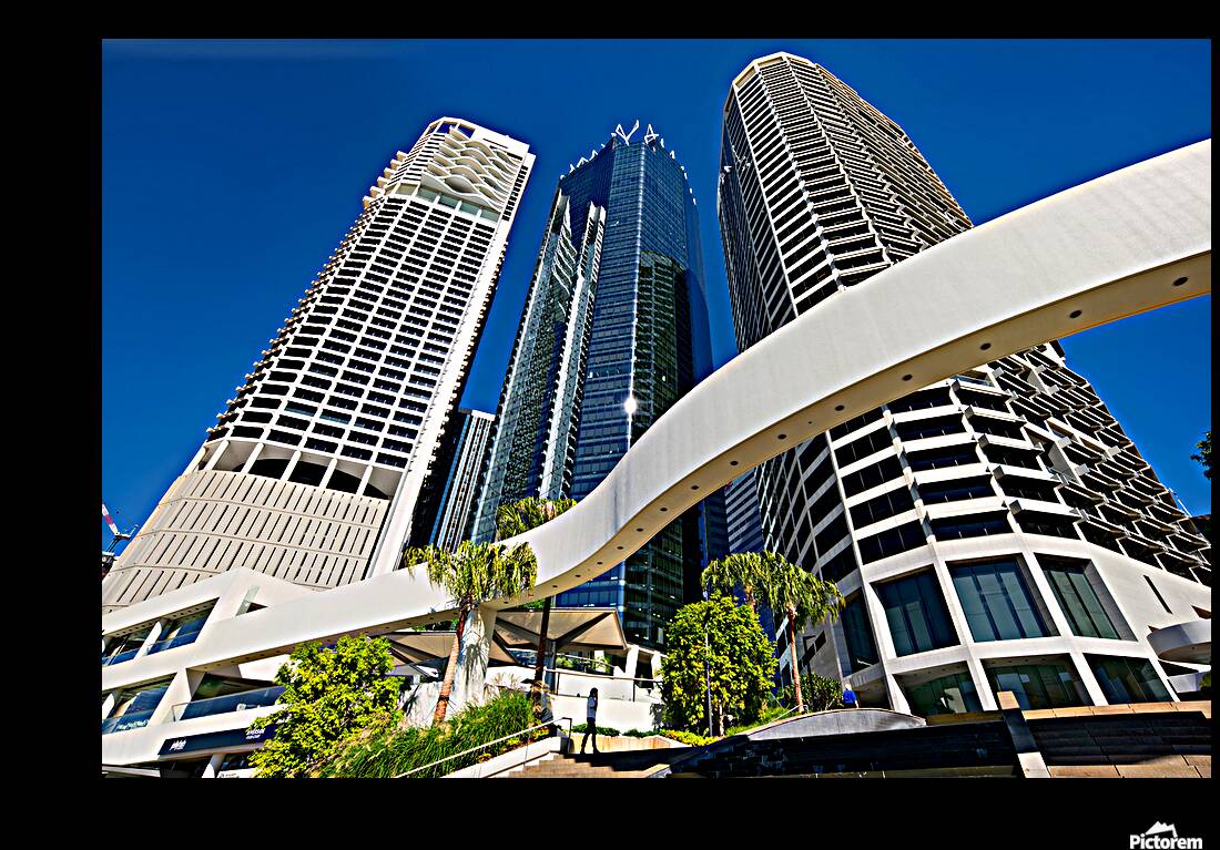 Woman walks on stairs in modern urban area with tall buildings Reproduction