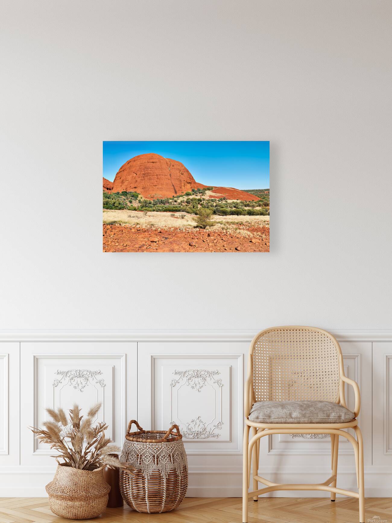 Vast red rock formation under a clear blue sky. Reproduction
