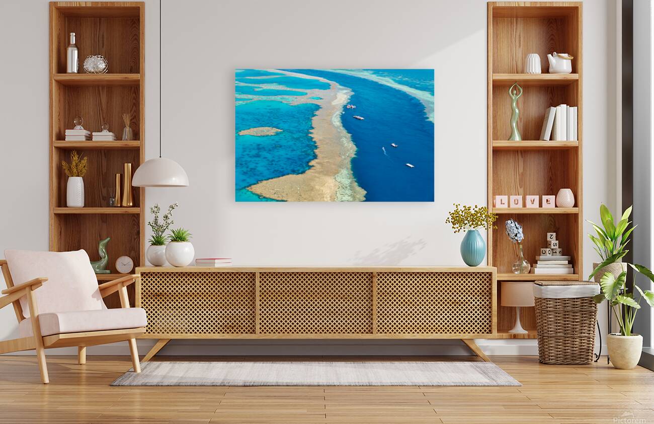 Aerial view of coral reefs and boats in turquoise ocean. Reproduction