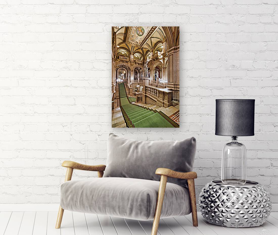 Ornate grand staircase with green carpet and classical statues. Reproduction