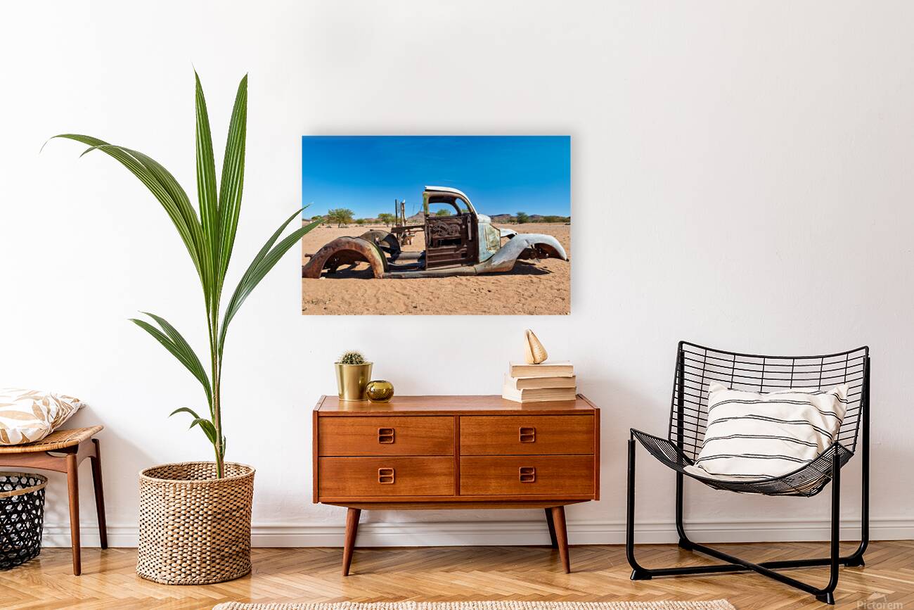 Classic car wreck rests in the Namib desert under a clear sky Reproduction