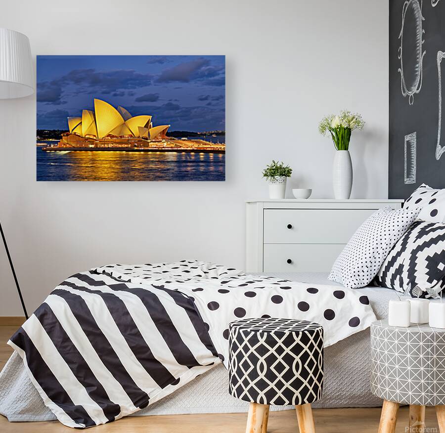 Sydney Opera House illuminated at dusk with harbor lights. Reproduction