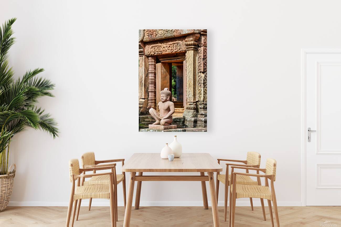 Ancient Cambodian temple with intricate carvings and stone statu Reproduction