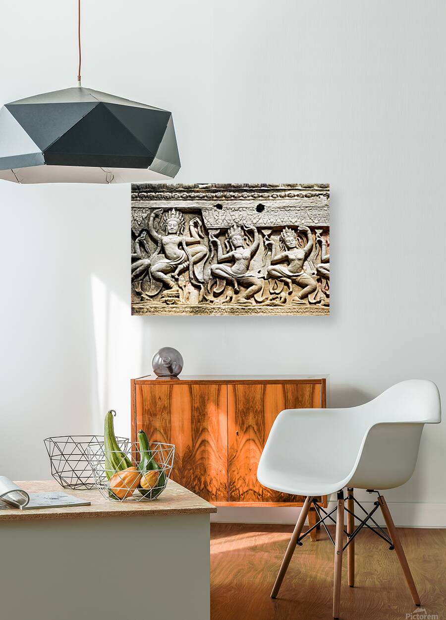 Ancient stone carvings of dancing Apsaras on a temple wall. Reproduction