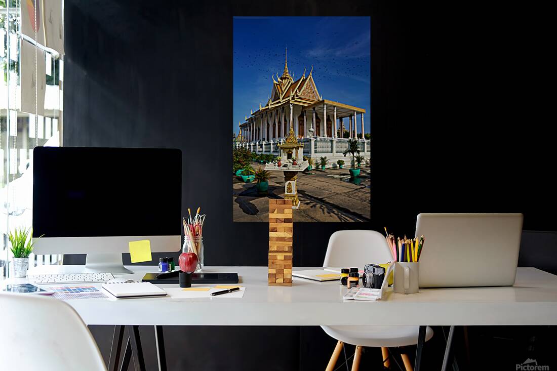 Majestic Cambodian temple under a blue sky with flying birds. Reproduction