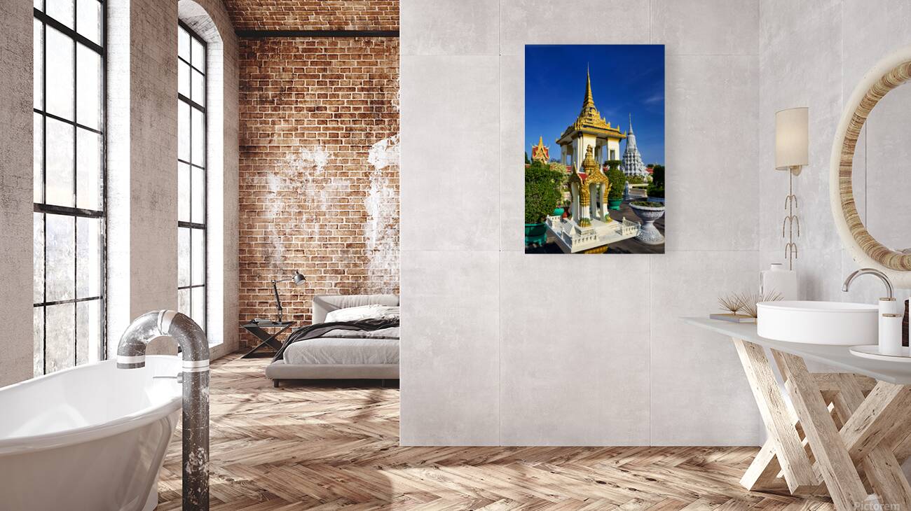 Golden temples and a grey stupa under a clear blue sky. Reproduction