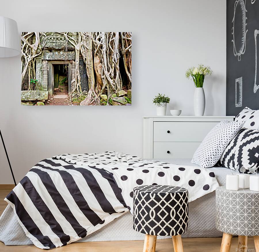 Ancient temple ruins consumed by massive tree roots. Reproduction