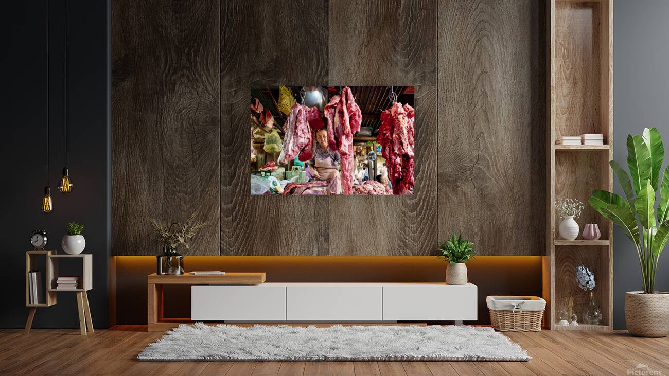 Woman selling raw meat in a bustling market. Reproduction