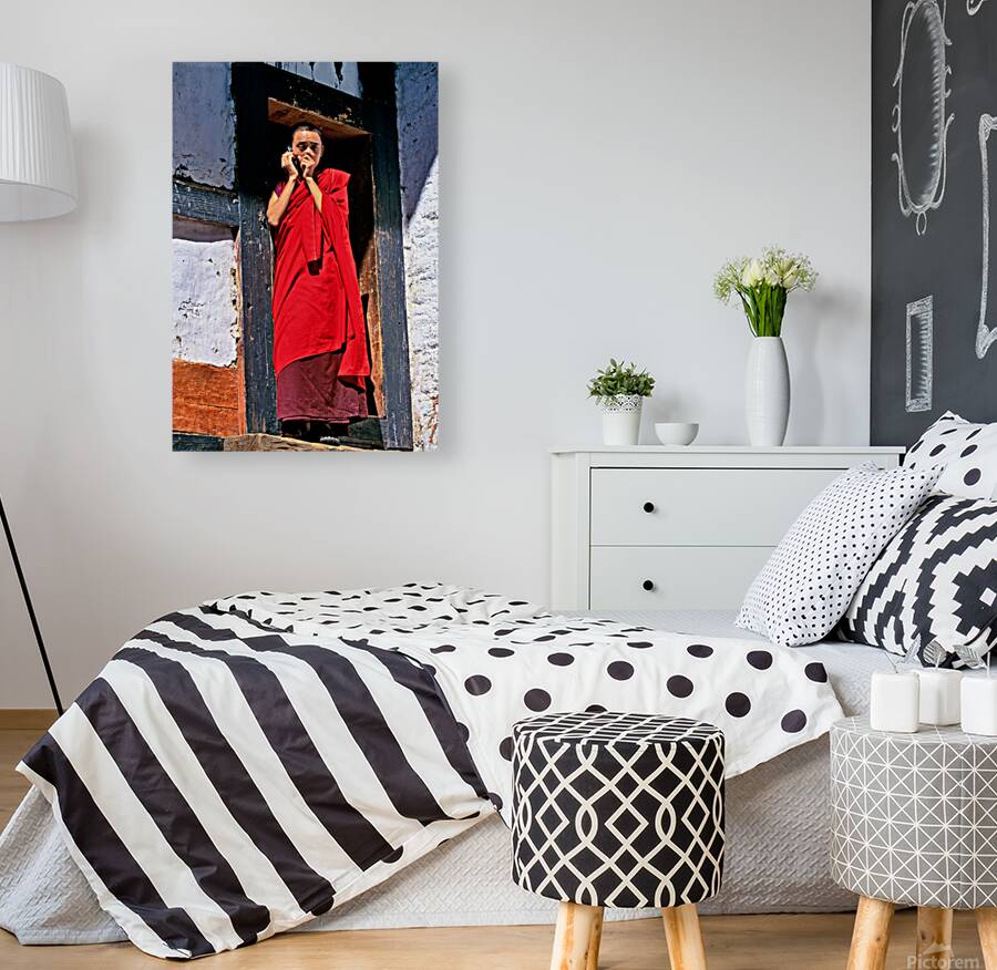 Monk in red robes on cell phone. Reproduction